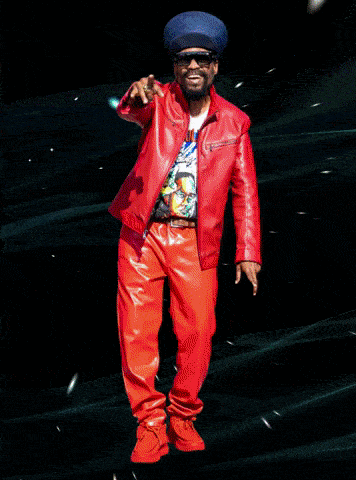 a man wearing a blue jacket and blue pants is dancing
