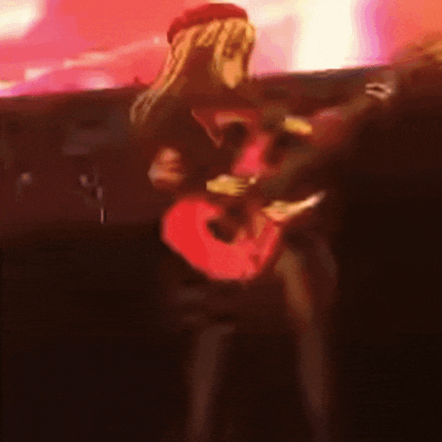 a girl is playing a red guitar with the number 3 on it