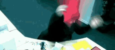 a blurry picture of a person holding a red item