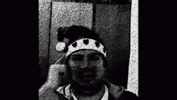 a black and white photo of a man wearing a t-shirt that says `` arabic '' .