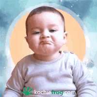 a baby making a funny face with the website kochiefrog.com in the corner