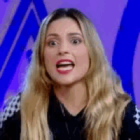 a woman with long blonde hair is making a funny face .