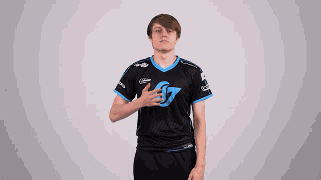 a young man wearing a black and blue shirt with the letter g on it