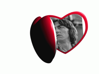 a heart shaped mirror with a picture of a man inside