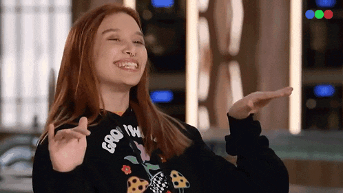a girl wearing a black hoodie that says groovy on it