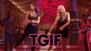 two women are dancing in front of a fireplace with the word tgif written in pink .
