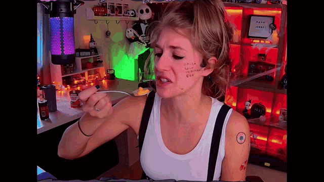 a woman with a tattoo on her face eating food