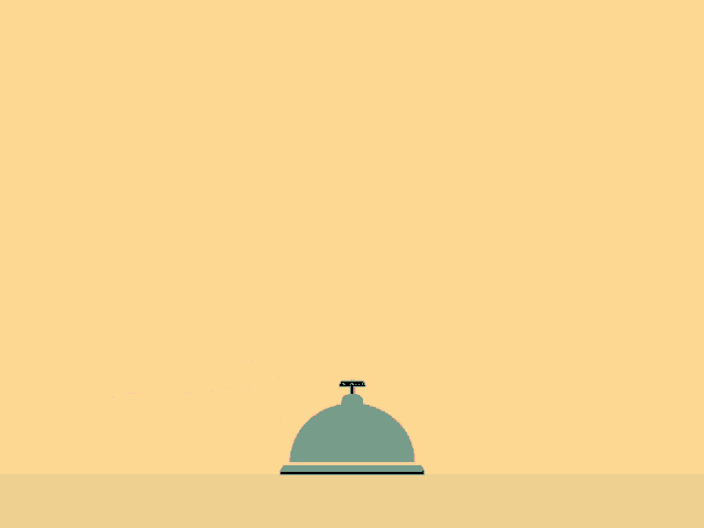 a hand giving a thumbs up next to a bell on a table