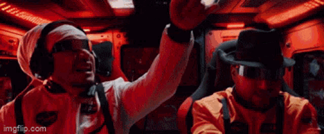 a man wearing a bandage on his head is giving a high five to another man