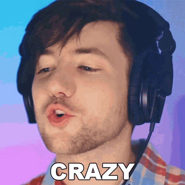 a man wearing headphones and a plaid shirt has the word crazy written on his face