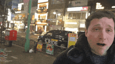 a man stands in front of a s.ride sign