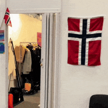 a norwegian flag hangs on a wall next to a doorway