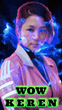 a woman in a pink jacket stands in front of a blue background with wow keren written on it