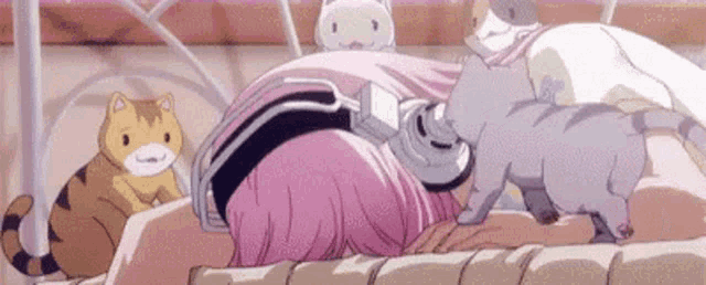 a girl with pink hair is laying on a bed with cats around her .