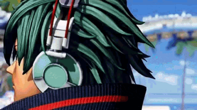 a close up of a person wearing headphones and a sweater .