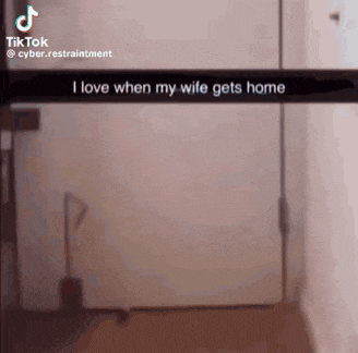 a person is standing in front of a door with a snapchat that says `` i love when my wife gets home ''