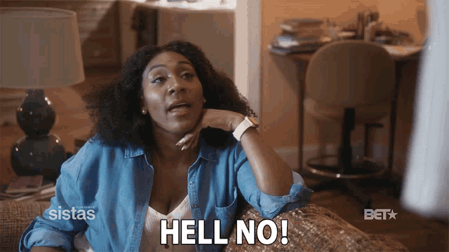 a woman is sitting on a couch and says " hell no "