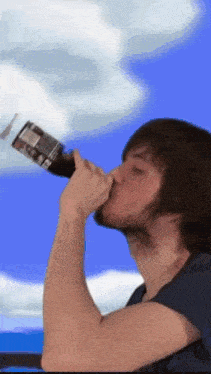 a man drinking from a bottle with a label that says ' coca cola ' on it