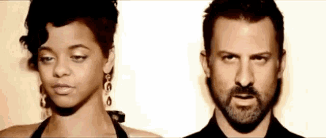 a man and a woman are standing next to each other .