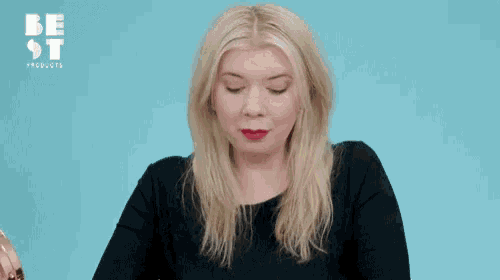 a woman is holding a card that says the balm