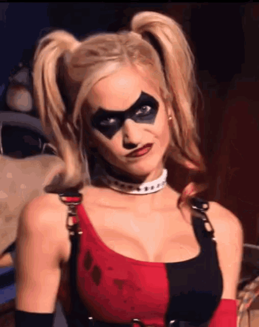 a woman in a harley quinn costume has pigtails on her head