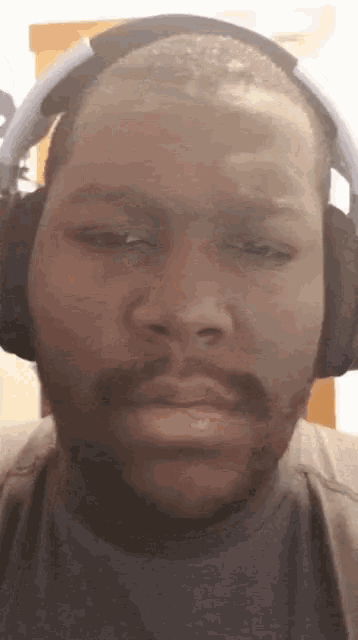 a man wearing headphones is making a face