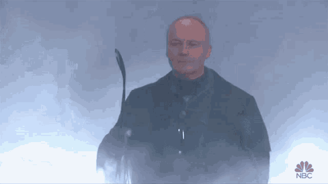 a man holding a hockey stick with nbc written on the bottom