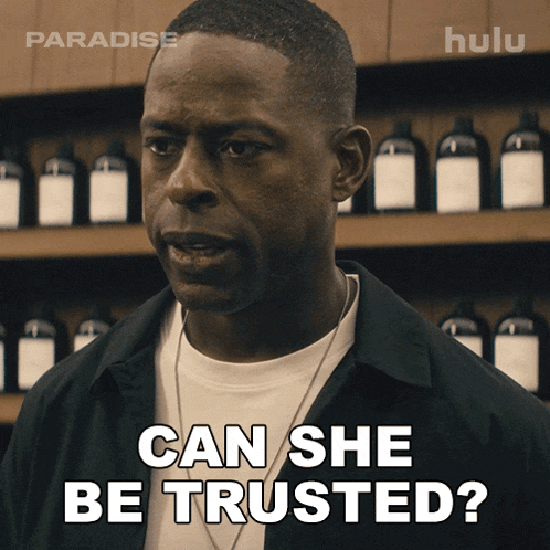 a man says can she be trusted in front of a shelf of bottles