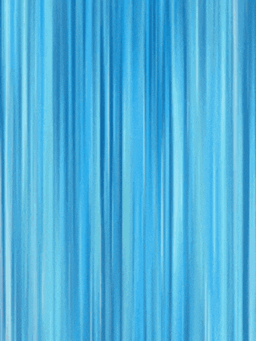 a man in a pink and black outfit is kicking in front of a blue curtain