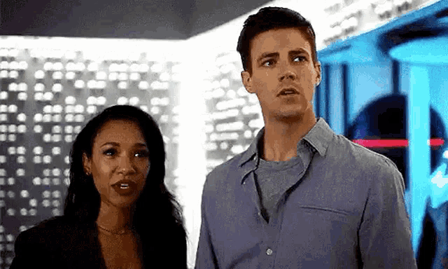 a man and a woman standing next to each other in a room .