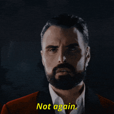 a man with a beard says not again in yellow letters