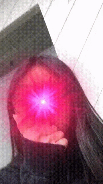 a close up of a person 's face with a red light shining on it