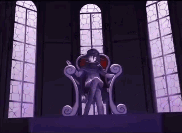 a statue of a person sitting on a throne in front of a window in a dark room .