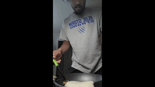 a man is cooking a pancake in a pan