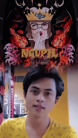 a man in a yellow shirt is standing in front of a poster with skulls and the word " nguy " on it