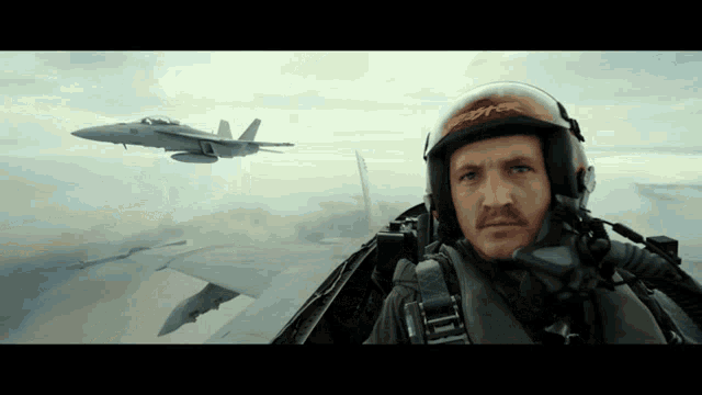 a man in a fighter jet is wearing a helmet that says space