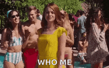 a woman in a yellow dress is standing in front of a crowd of people in bikinis .