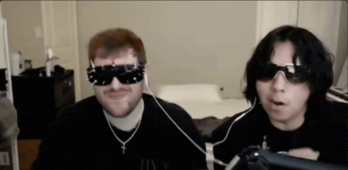 a man wearing sunglasses and a necklace with a cross