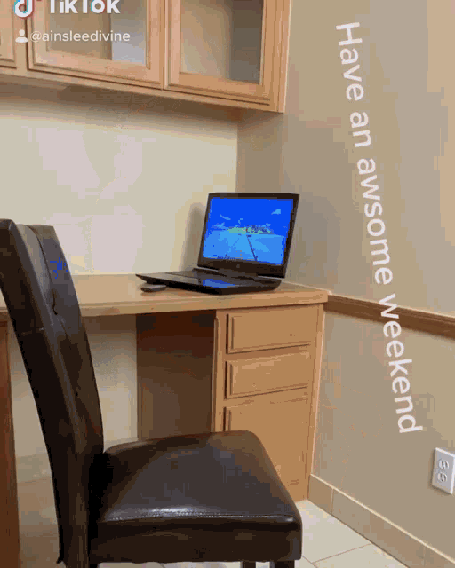 a laptop sits on a desk next to a chair with the words have an awesome weekend below it