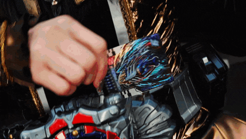 a person is playing with a toy that looks like a transformers toy .