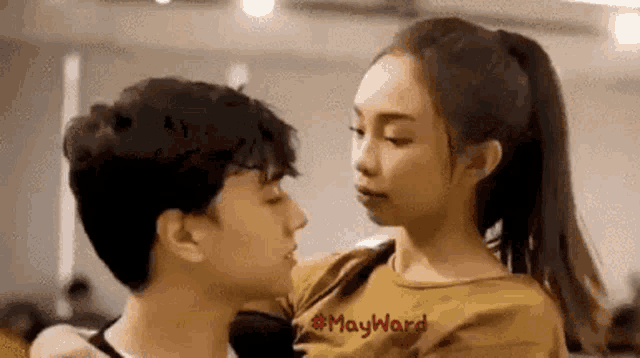 a man and a woman are kissing each other in a dance studio .