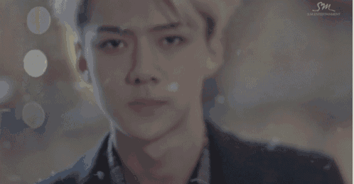 a close up of a man 's face with sm entertainment written in the corner