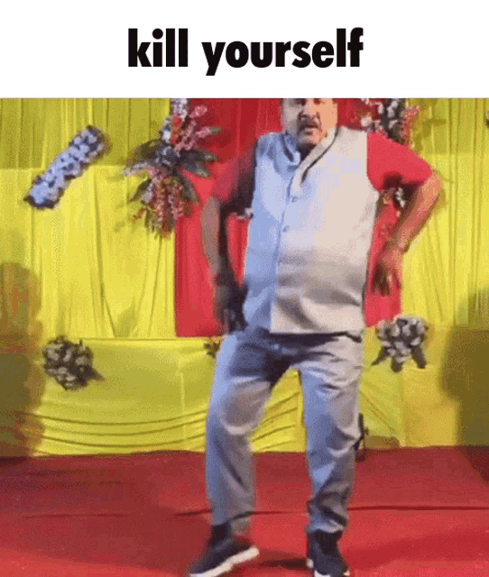 a man is dancing in front of a yellow curtain with the words kill yourself on the bottom