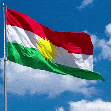 a red white and green flag with a yellow sun on it