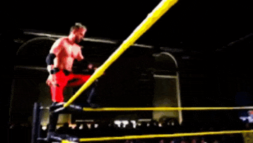 a blurry picture of a wrestling ring with a crowd watching