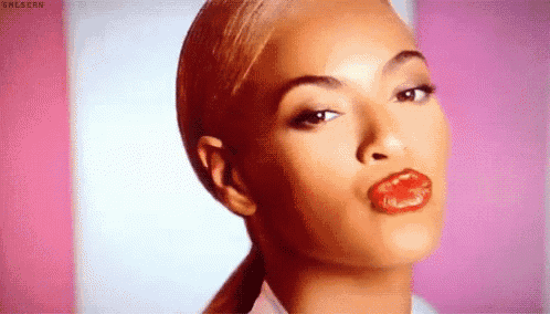a woman with red lips and a ponytail is making a funny face .
