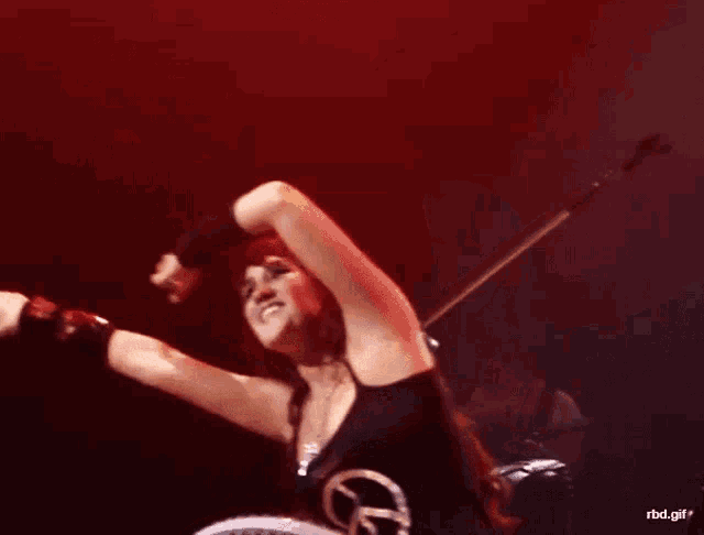 a woman wearing a black tank top that says peace