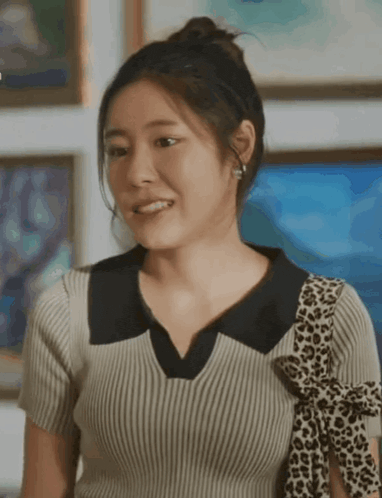 a woman wearing a leopard print scarf around her neck