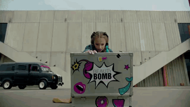 a girl looking into a beauty bomb case