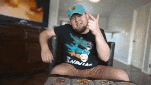 a man wearing a shirt that says ' 3ninja ' on it